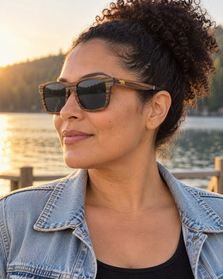 Lake Arrowhead polarized sunglasses worn by a woman on a wooden dock at Lake Arrowhead
