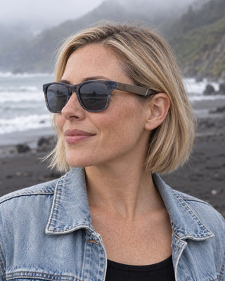 Lost Coast polarized sunglasses worn by a woman on a black sand beach on the Lost Coast