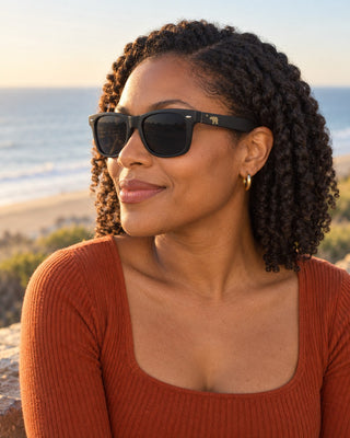 Santa Monica polarized sunglasses worn by a woman on the coastal bluffs at sunset
