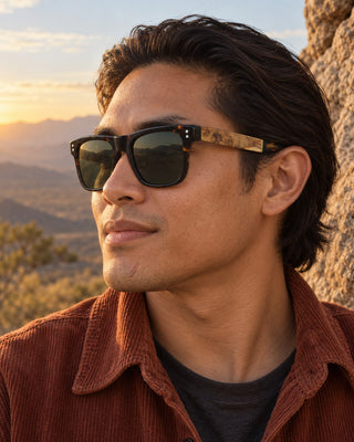 Toro Peak polarized sunglasses worn by a man at a desert mountain viewpoint at golden hour