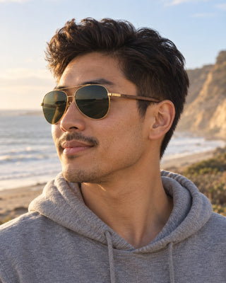 Torrey Pines polarized sunglasses worn by a man on the beach below the Torrey Pines cliffs